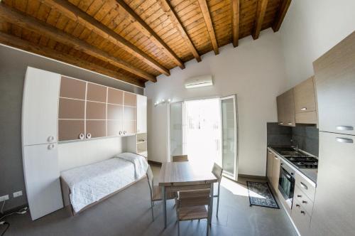 a kitchen with a desk and a table in a room at Villa Giambona in Isola delle Femmine