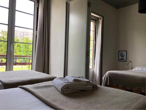 a hotel room with two beds and a window at Most Art Boutique Hostel in Leiria