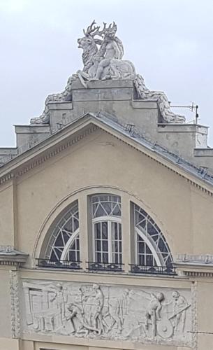a building with a statue on top of it at Planet Hostel in Warsaw