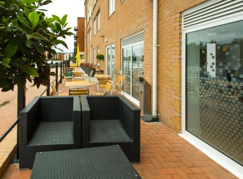 a black bench sitting on the side of a building at Holiday Inn Express Cardiff Bay by IHG in Cardiff