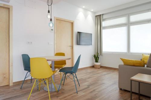 a dining room with a table and chairs at Apartamentos Isaga in Zarautz
