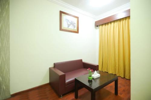 a living room with a couch and a table at Mermaid Beach Hotel LLC in Ajman 