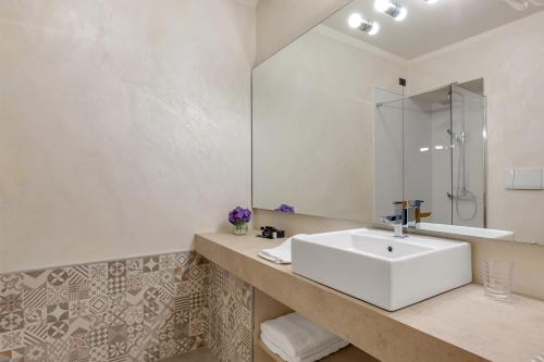 a bathroom with a white sink and a mirror at Hotel Ancora in Verbania