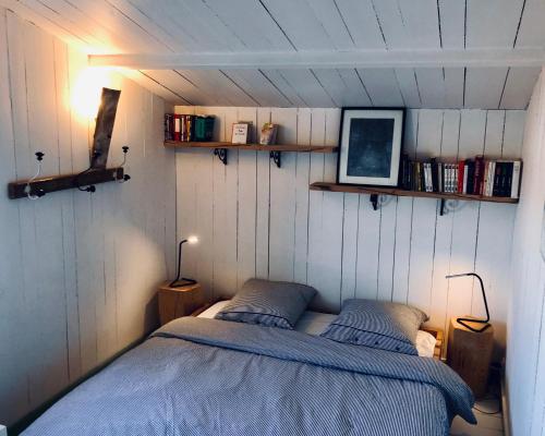 a bedroom with two beds in a small room at Logement Design à Loix-en-Ré - 2 étoiles - Centre Village in Loix