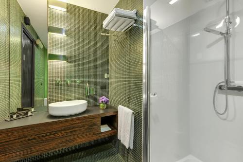 a bathroom with a sink and a shower at Hotel Ancora in Verbania