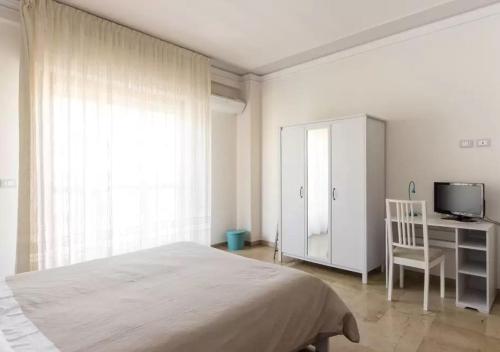 a bedroom with a bed and a desk and a tv at Your Room in Catania in Catania