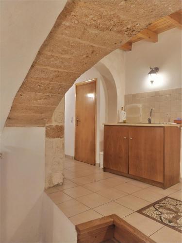 a large kitchen with a sink and a counter at Odyssey House in Chania