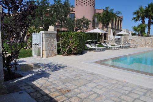 a villa with a swimming pool and a fence at Villa Rosa Antico Dimora Storica in Otranto