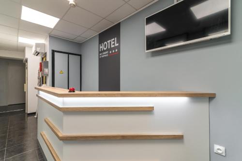 an office lobby with a hotel sign on the wall at Hotel des Congrès et Festivals in Cannes