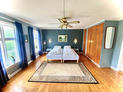 a bedroom with two beds and a ceiling fan at Villa Edvin - Slow living in Eide