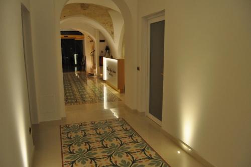 a hallway with an aisle with a rug on the floor at Villa Rosa Antico Dimora Storica in Otranto