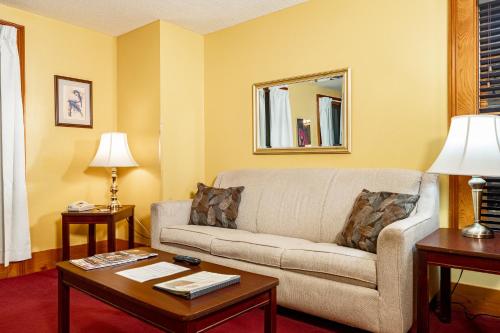 a living room with a couch and a table at Hotel de la Monnaie, French Quarter in New Orleans