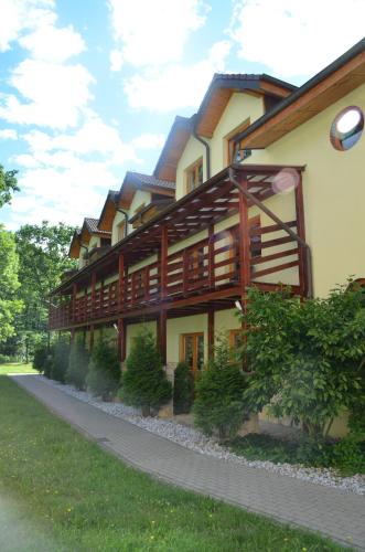 a large building with wooden panels on it at Hotel Tenis in Chrząstowice