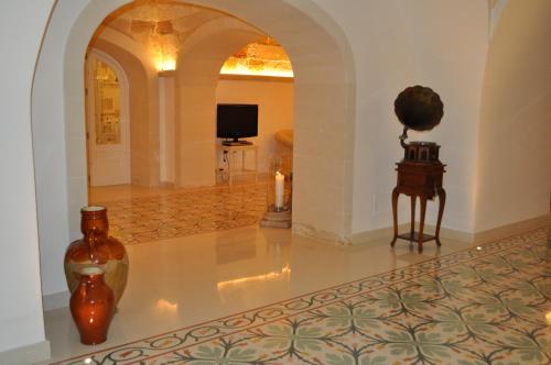 a living room with a candle and vases on the floor at Villa Rosa Antico Dimora Storica in Otranto