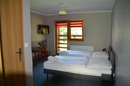 Postel nebo postele na pokoji v ubytování Hotel Tenis