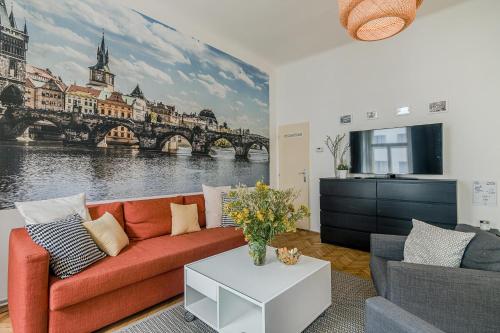 a living room with a couch and a painting of a bridge at APT in center Prague w Netflix by Michal&Friends in Prague
