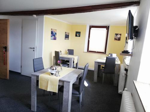 a dining room with tables and chairs and a window at Pension Riverside in Leverkusen Hitdorf am Rhein - Zentral an der A1 und 59 in Leverkusen
