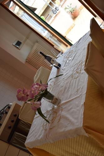 a table with a vase with flowers on it at Terrazza in borgo San Jacopo in Florence
