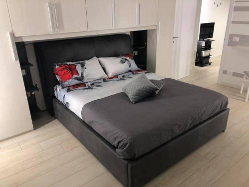 una gran cama negra con almohadas en una habitación en Rosa dei Venti B&B en Petacciato