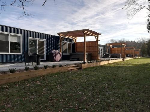 a house with a porch and a gazebo at Inner Joy Getaways in Elora