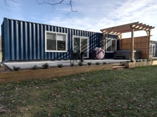 a tiny house with a blue and white stripes at Inner Joy Getaways in Elora