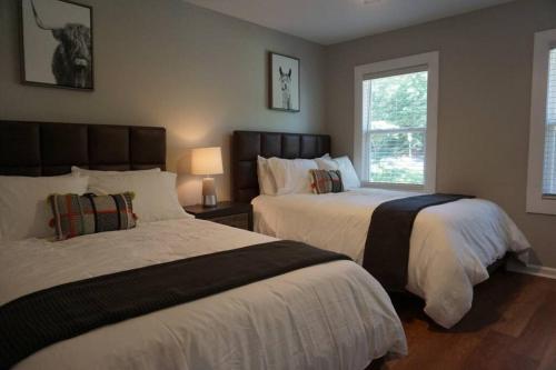 a bedroom with two beds and a window at Beautiful & large newly renovated 5 bedroom house. in Marietta