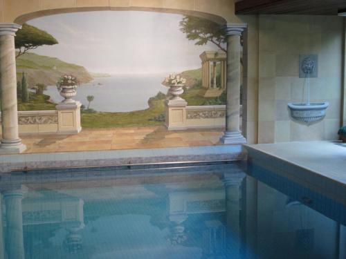 a swimming pool with a painting on the wall at Naturkost-Hotel Harz in Bad Grund