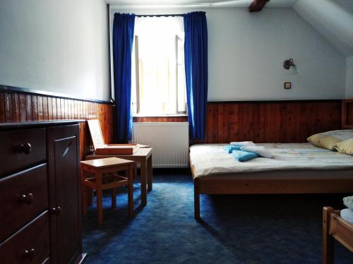 a hotel room with two beds and a window at Penzion U Lucerny s malou farmičkou in Kytlice