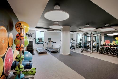 a gym with treadmills and ellipticals in a room at THesis Hotel Miami Coral Gables, Curio Collection by Hilton in Miami