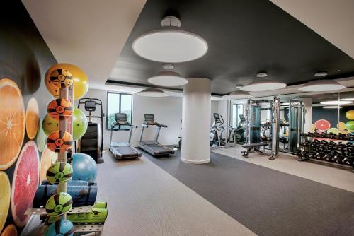 a gym with treadmills and ellipticals in a room at THesis Hotel Miami in Miami