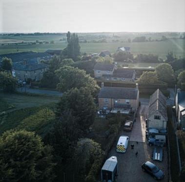 an aerial view of a town with buses parked in a parking lot at Ye Olde Globe & Chequers in Huntingdon