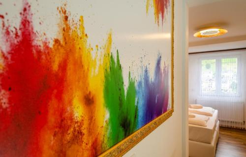 a colorful painting on a wall in a room at MoselUnion - "schlafen & genießen" in Cochem