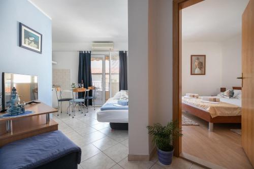 a bedroom with a bed and a desk in a room at Apartments Barba in Tučepi