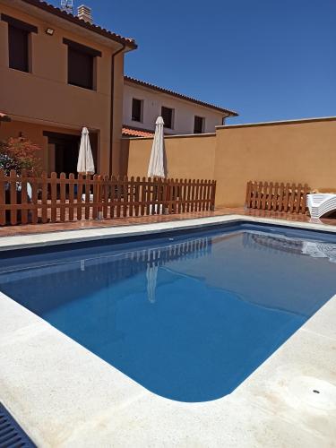 a swimming pool in front of a house at La Casa de Belén in La Torre del Valle