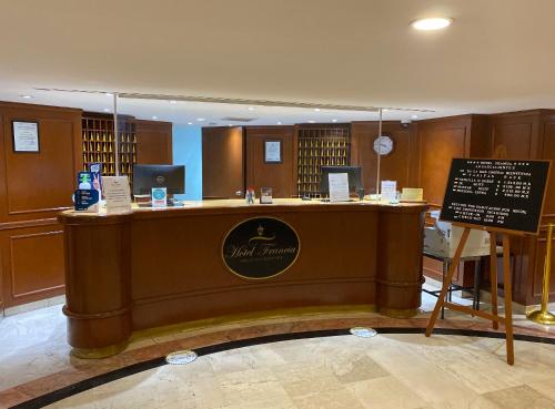 a large counter in a library with a sign at Hotel Francia Aguascalientes in Aguascalientes