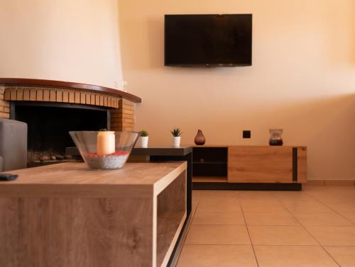 a living room with a flat screen tv on the wall at John's Apartments in Karistos