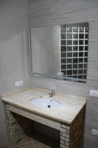 a bathroom with a sink and a mirror at CUEVAS AL ANDALUS - Solea in Orce