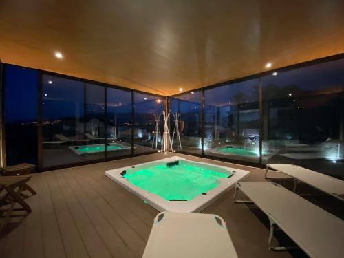 a large swimming pool on the roof of a building at Casa de Lagarinhos JACUZZI SPA JOGOS GYM - SERRA DA ESTRELA - SEIA - GOUVEIA in Gouveia