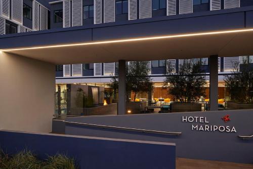a hotel margaoza with a sign in front of it at Hotel Mariposa in Los Angeles