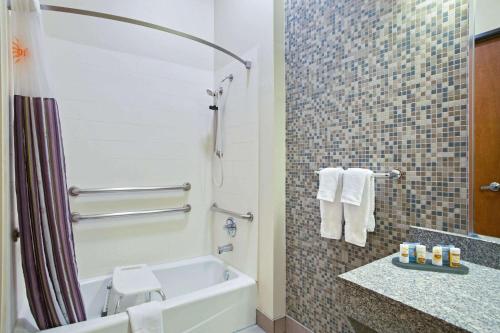 a bathroom with a tub and a toilet and a sink at La Quinta by Wyndham Austin NW/Lakeline Mall in Cedar Park