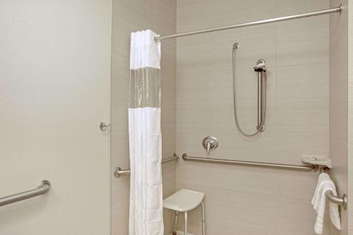 a bathroom with a shower and a toilet at La Quinta by Wyndham Grand Forks in Grand Forks