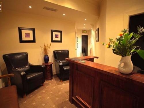 a lobby with black chairs and a bar with a counter at Rab Ha's in Glasgow