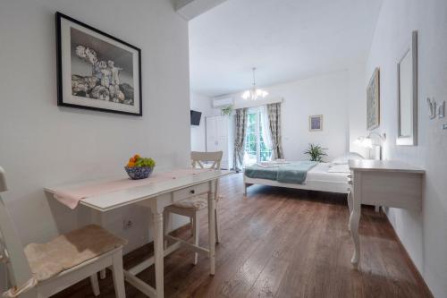 a room with a desk and a bed in the background at Marinero Apartments in Budva