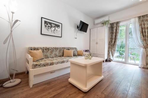 a living room with a couch and a table at Marinero Apartments in Budva
