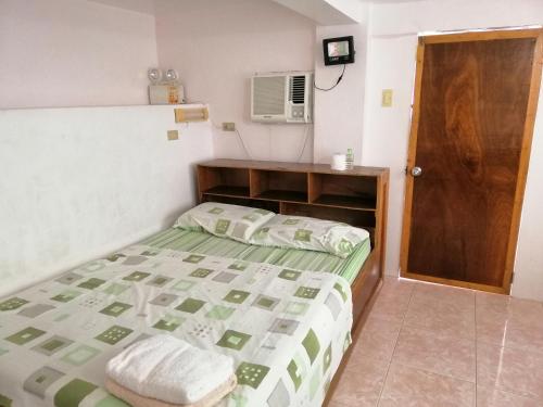 a small bedroom with a bed and a microwave at VRC Resort in Almeria