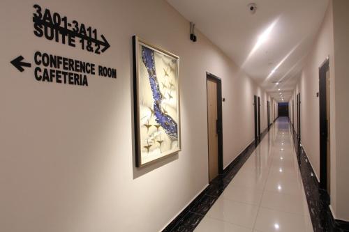 a corridor in a building with paintings on the wall at D&F BOUTIQUE HOTEL SEREMBAN 2 in Seremban