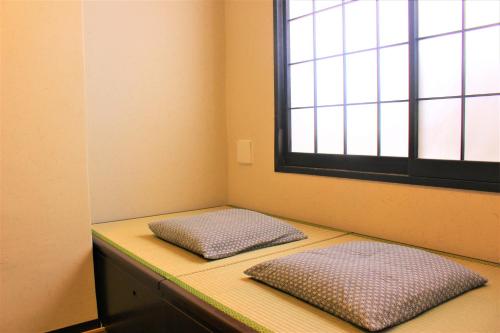 Ένα ή περισσότερα κρεβάτια σε δωμάτιο στο K's House Tokyo Oasis - Quality Hostel in Asakusa
