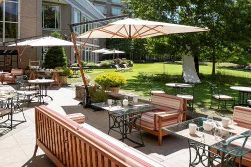 a patio with tables and chairs and an umbrella at Sendai Royal Park Hotel in Sendai