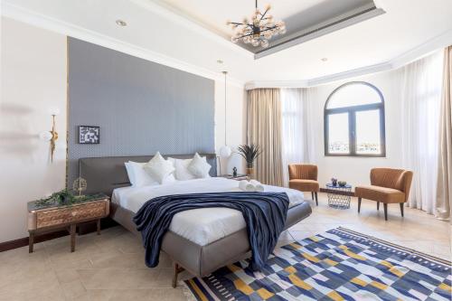 a bedroom with a large bed with a blue wall at Stella Stays Exceptional 4 BDR Palm Villa Beach Private Pool in Dubai