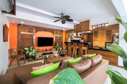 a living room with a couch and a table at CASA MIMBA - Seaview Private Pool Villa Padangbai in Padangbai